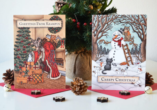 Griezelige Kerstkaarten Set x 6 Zes Monster en Katten Wenskaarten Krampus Enge Sneeuwman Gothic Kerstmis Poezen Illustraties Spooky Folklore Kerstkaart Creepy Christmas Felicitatie Feestdagen Kaart